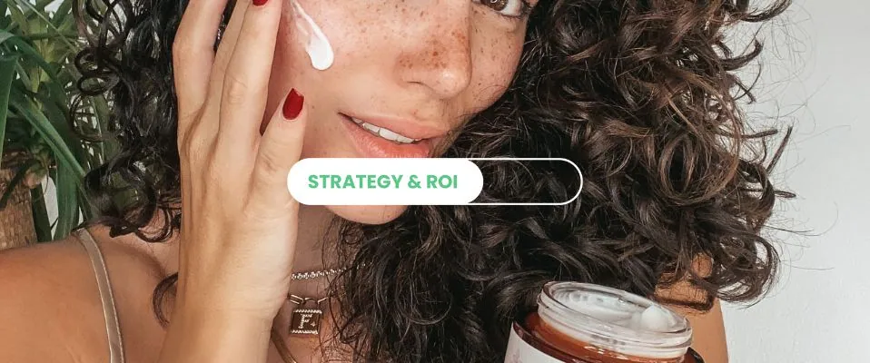 Woman with curly hair applying cream to her face while holding the jar, with a Strategy & ROI label