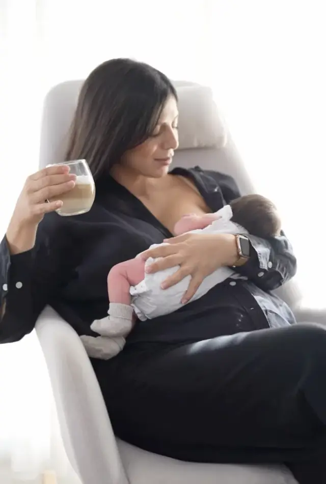 De'Longhi Rivelia — creator with a coffee, holding a newborn